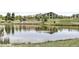 Scenic pond surrounded by lush greenery, reflecting the community clubhouse and landscaping at 16549 Prospect Ln, Broomfield, CO 80023