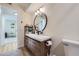 Updated bathroom features a modern vanity with round mirror and stylish fixtures at 12131 Melody Dr # 201, Denver, CO 80234