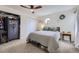 Cozy bedroom features carpet, ceiling fan, window with a view, and large closet with storage at 12131 Melody Dr # 201, Denver, CO 80234