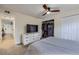 Bedroom features include carpet, ceiling fan, closet space, and dresser with mounted television at 12131 Melody Dr # 201, Denver, CO 80234