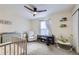 Bedroom features carpet, white walls, a baby crib, and baby furniture at 12131 Melody Dr # 201, Denver, CO 80234