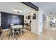 Dining area with round table and chairs, modern lighting, and decorative wood paneling at 12131 Melody Dr # 201, Denver, CO 80234