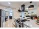 Bright kitchen showcasing white cabinets, stainless steel appliances, and an open layout at 12131 Melody Dr # 201, Denver, CO 80234
