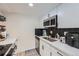 Bright kitchen features modern appliances, white cabinets, quartz countertops, and decorative backsplash at 12131 Melody Dr # 201, Denver, CO 80234