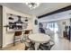 Open concept kitchen and dining area with stainless appliances, white cabinets, breakfast bar, and modern lighting at 12131 Melody Dr # 201, Denver, CO 80234