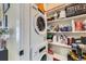 Efficient laundry area includes stacked washer and dryer, with storage shelving at 12131 Melody Dr # 201, Denver, CO 80234