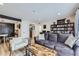 Comfortable living room with a plush sofa, accent chair, wood floors, and stylish décor at 12131 Melody Dr # 201, Denver, CO 80234