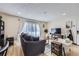 Cozy living room featuring a comfortable sofa, TV, and natural light from the sliding doors at 12131 Melody Dr # 201, Denver, CO 80234