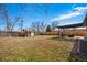 Large backyard with wooden fence, storage shed, and covered patio with seating at 1270 S Lowell Blvd, Denver, CO 80219