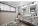 Charming bathroom with patterned tile floor, and double sink vanity with storage at 1270 S Lowell Blvd, Denver, CO 80219