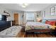 Bright bedroom with wood floors, area rug, and cozy bed with floral bedding at 1270 S Lowell Blvd, Denver, CO 80219