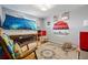 Fun bedroom features a bunk bed, blue themed decor, and toy shelving at 1270 S Lowell Blvd, Denver, CO 80219