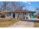 Charming single-story home with a blue door and neatly landscaped front yard, perfect for curb appeal at 1270 S Lowell Blvd, Denver, CO 80219