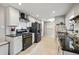 Spacious kitchen with stainless steel appliances, granite countertops, and classic white cabinets at 1270 S Lowell Blvd, Denver, CO 80219