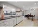 Well-lit kitchen with granite counters and white cabinets that opens to the dining area at 1270 S Lowell Blvd, Denver, CO 80219