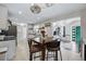 Open kitchen with dining area provides ample counter space, appliances, and natural light at 1270 S Lowell Blvd, Denver, CO 80219