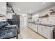 Modern kitchen boasts granite countertops, white cabinetry, subway tile backsplash, and stainless steel appliances at 1270 S Lowell Blvd, Denver, CO 80219