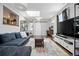 Spacious living room with a skylight, hardwood floors, and an inviting open layout at 1270 S Lowell Blvd, Denver, CO 80219