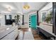 Inviting living room with a bright teal door, modern shelving and abundant natural light at 1270 S Lowell Blvd, Denver, CO 80219