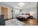 Main bedroom features a decorative rug, wood floors, and a large window for natural light at 1270 S Lowell Blvd, Denver, CO 80219
