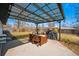 Outdoor patio with covered pergola, string lights, grill, and dining table at 1270 S Lowell Blvd, Denver, CO 80219