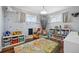 Bright playroom with hardwood floors, toy organizers, and colorful road rug at 1270 S Lowell Blvd, Denver, CO 80219