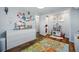 Playroom with dresser and play kitchen opens to closet and other rooms at 1270 S Lowell Blvd, Denver, CO 80219