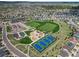 An aerial view showcases a well-maintained community park with sports fields, tennis courts, and playground facilities at 1133 Lucky Ct, Castle Rock, CO 80109