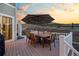 Back deck with dining table and umbrella, providing a perfect setting for outdoor gatherings at 1133 Lucky Ct, Castle Rock, CO 80109