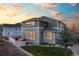 A well-maintained backyard features a lawn, patio, and a two-story home with abundant windows for natural light at 1133 Lucky Ct, Castle Rock, CO 80109