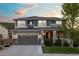 Charming home with stone accents, a covered front porch, and a two-car garage against a colorful sunset at 1133 Lucky Ct, Castle Rock, CO 80109