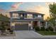 Beautiful two-story home with a well-manicured lawn and a welcoming front porch under a colorful sky at 1133 Lucky Ct, Castle Rock, CO 80109