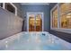 Hot tub with a view of the house through sliding glass doors creating a private and relaxing space at 1133 Lucky Ct, Castle Rock, CO 80109