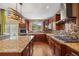 Modern kitchen with granite countertops, stainless appliances and stylish vent hood at 1133 Lucky Ct, Castle Rock, CO 80109