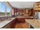 Modern kitchen with stainless appliances, gorgeous granite countertops, and wood flooring at 1133 Lucky Ct, Castle Rock, CO 80109