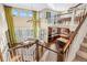 Open-concept living room boasts high ceilings, many windows, a leather sofa, and a modern kitchen at 1133 Lucky Ct, Castle Rock, CO 80109