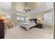 Spacious main bedroom features a tray ceiling, ceiling fan, large windows, and a comfortable bed at 1133 Lucky Ct, Castle Rock, CO 80109