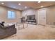 Finished basement with carpeted floors, entertainment area, and natural light from window at 8018 Williams Fork Ave, Littleton, CO 80125