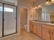 Bright bathroom with double vanity, granite countertop, and modern tiled shower at 8018 Williams Fork Ave, Littleton, CO 80125