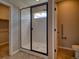 Modern bathroom featuring tiled shower with glass door and accessible features at 8018 Williams Fork Ave, Littleton, CO 80125