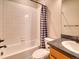 Clean bathroom featuring a shower-tub combo with white tile and a stylish vanity with modern fixtures at 8018 Williams Fork Ave, Littleton, CO 80125