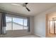 Comfortable bedroom with carpet, large window and modern ceiling fan at 8018 Williams Fork Ave, Littleton, CO 80125