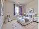 Bright bedroom features a large window with violet curtains, light walls, and stylish décor at 8018 Williams Fork Ave, Littleton, CO 80125