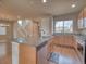 Open kitchen features a granite counter island with stainless steel appliances and wooden cabinets at 8018 Williams Fork Ave, Littleton, CO 80125