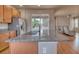 Kitchen with granite counters, stainless steel appliances, and an open view to the living room at 8018 Williams Fork Ave, Littleton, CO 80125