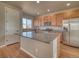 Kitchen with an island, granite counters, stainless steel appliances, and wood cabinets at 8018 Williams Fork Ave, Littleton, CO 80125
