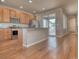 Kitchen with stainless appliances, granite counters, light wood cabinets, and sliding glass door at 8018 Williams Fork Ave, Littleton, CO 80125