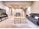 Spacious living room with plush carpet, modern furnishings, and a staircase leading to the upper level at 8018 Williams Fork Ave, Littleton, CO 80125