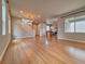 Bright and airy living room with wood floors and staircase at 8018 Williams Fork Ave, Littleton, CO 80125