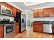 Kitchen with stainless steel appliances and wood cabinets at 10985 W Dumbarton Cir, Littleton, CO 80127